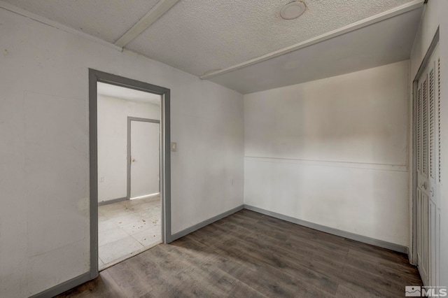 742 D St, Hawthorne, NV 89415 - unfurnished bedroom featuring a textured ceiling, wood finished floors, and a closet