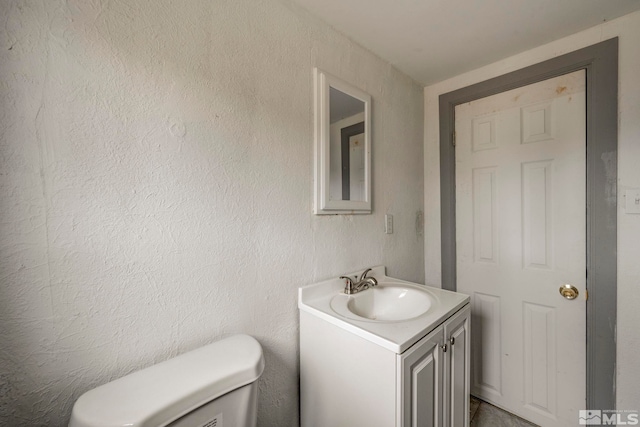 742 D St, Hawthorne, NV 89415 - half bath featuring vanity, toilet, and a textured wall