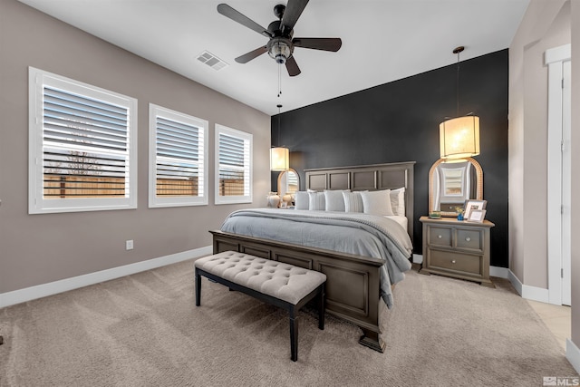 carpeted bedroom with baseboards and a ceiling fan