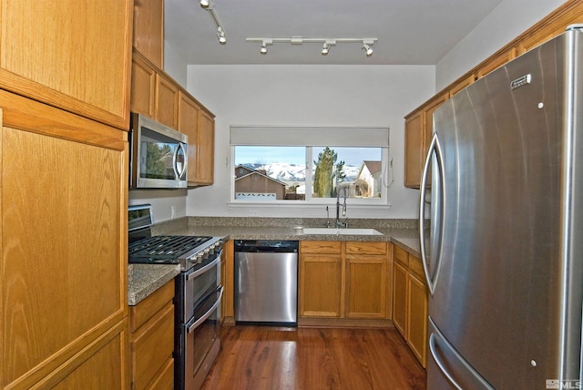 3953 Boundary Peak Ct, Reno, NV 89508 - kitchen with appliances with stainless steel finishes, a sink, brown cabinetry, and dark countertops