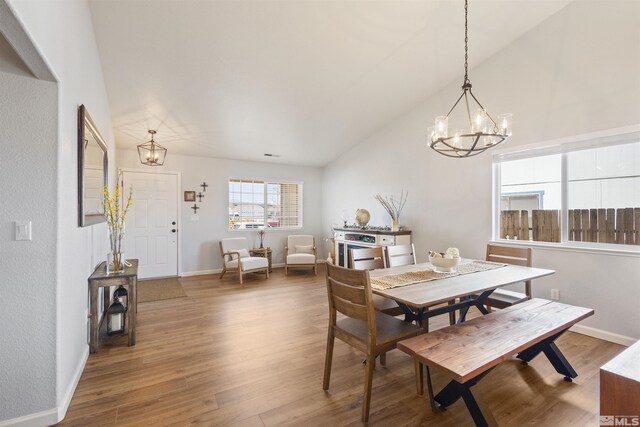 9834 Suncrest Dr, Reno, NV 89506 - dining room featuring a chandelier, wood finished floors, baseboards, and lofted ceiling