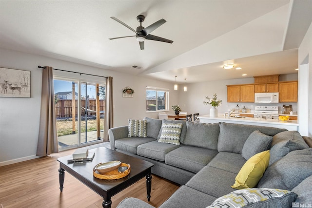 9834 Suncrest Dr, Reno, NV 89506 - living room with light wood finished floors, ceiling fan, lofted ceiling, and baseboards