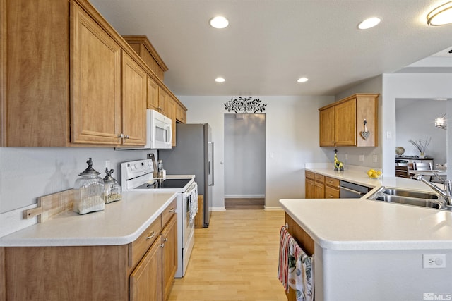 9834 Suncrest Dr, Reno, NV 89506 - kitchen featuring white appliances, a sink, light wood-style flooring, recessed lighting, and brown cabinetry