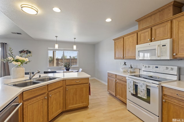 9834 Suncrest Dr, Reno, NV 89506 - kitchen with white appliances, a sink, light wood-style flooring, light countertops, and recessed lighting