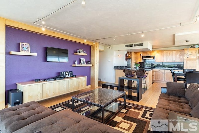 100 N Arlington Ave Unit 14F, Reno, NV 89501 - living room featuring track lighting and light wood-style floors