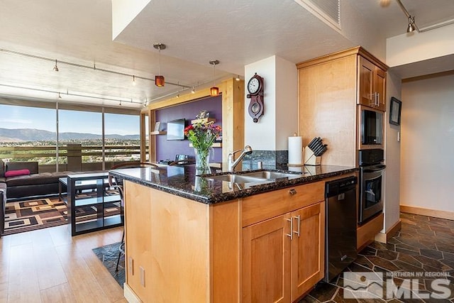 100 N Arlington Ave Unit 14F, Reno, NV 89501 - kitchen featuring rail lighting, a sink, dishwasher, oven, and dark stone counters