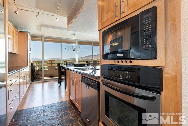 100 N Arlington Ave Unit 14F, Reno, NV 89501 - kitchen with appliances with stainless steel finishes, a sink, dark countertops, dark wood-type flooring, and brown cabinetry