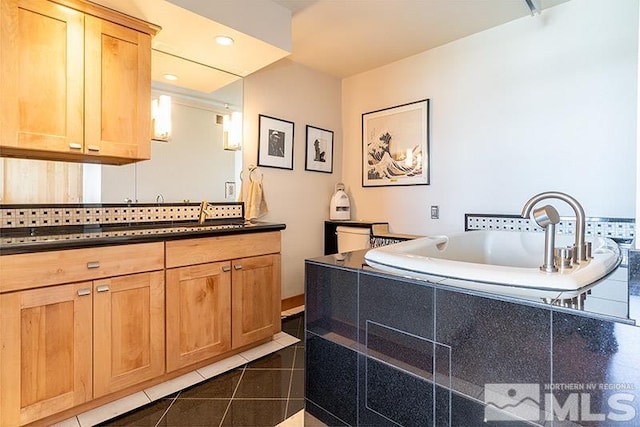 100 N Arlington Ave Unit 14F, Reno, NV 89501 - bathroom with tile patterned flooring, a garden tub, and vanity