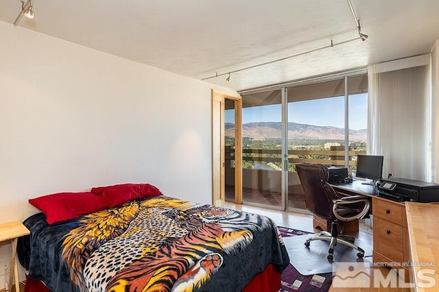 100 N Arlington Ave Unit 14F, Reno, NV 89501 - bedroom featuring track lighting, expansive windows, access to exterior, and a desk