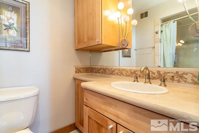 100 N Arlington Ave Unit 14F, Reno, NV 89501 - full bathroom with vanity, toilet, and a shower with shower curtain