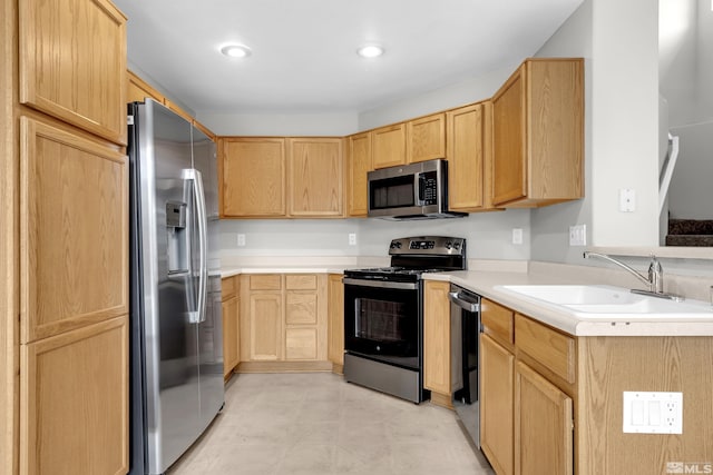 2130 Canyon Mesa Ct, Reno, NV 89523 - kitchen with stainless steel appliances, light brown cabinetry, a sink, light countertops, and recessed lighting