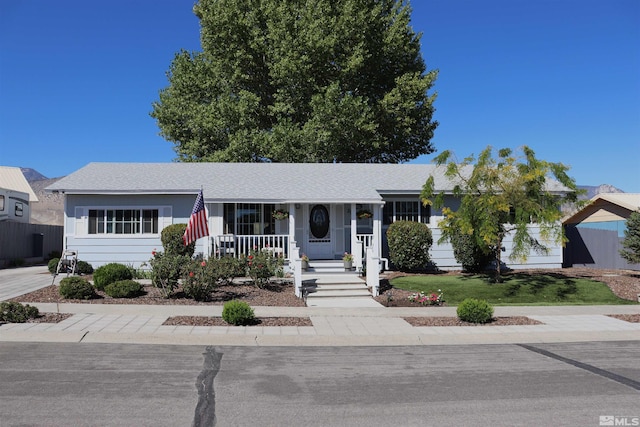 255 Ash St, Hawthorne, NV 89415 - ranch-style home with a porch and roof with shingles
