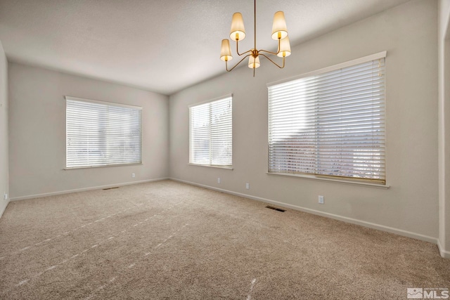 10055 Zephyr Heights Dr, Reno, NV 89521 - spare room with a chandelier, carpet floors, and baseboards