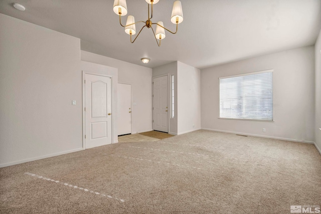 10055 Zephyr Heights Dr, Reno, NV 89521 - unfurnished room featuring carpet floors, a chandelier, baseboards, and a smoke detector
