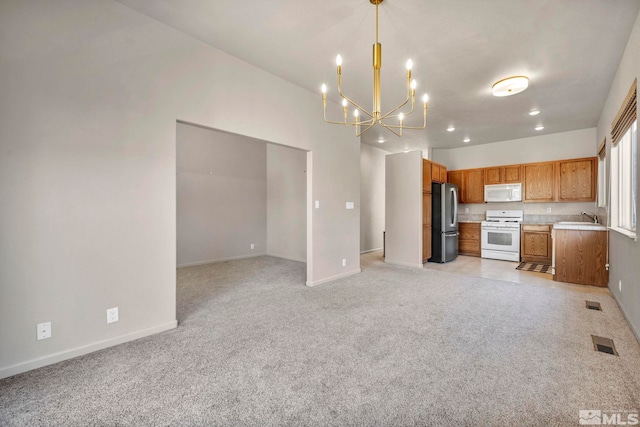 10055 Zephyr Heights Dr, Reno, NV 89521 - unfurnished living room featuring a sink, a chandelier, baseboards, light carpet, and recessed lighting