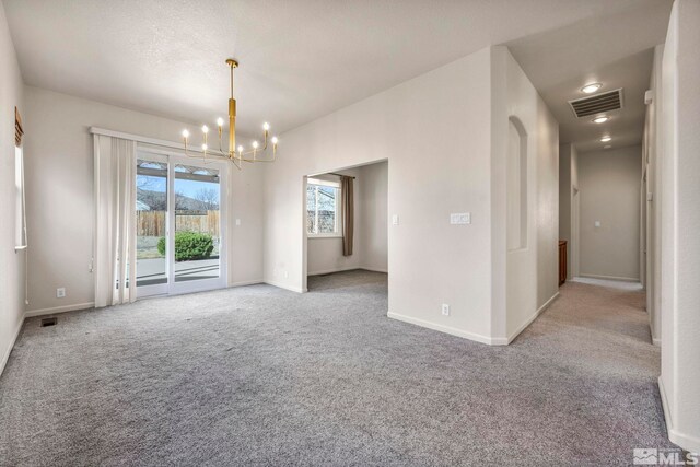 10055 Zephyr Heights Dr, Reno, NV 89521 - empty room featuring a chandelier, carpet floors, and baseboards