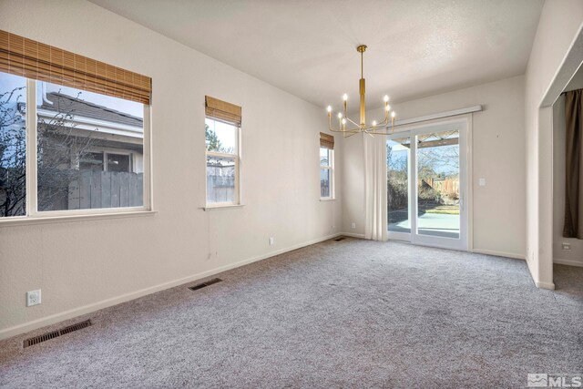 10055 Zephyr Heights Dr, Reno, NV 89521 - carpeted spare room with a chandelier, healthy amount of natural light, and baseboards