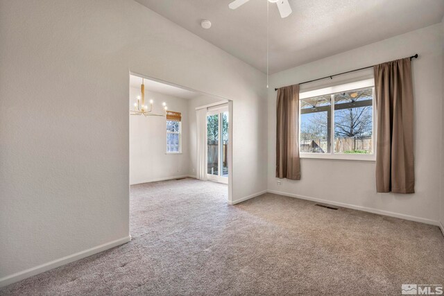 10055 Zephyr Heights Dr, Reno, NV 89521 - carpeted empty room featuring a chandelier, baseboards, a ceiling fan, and a smoke detector