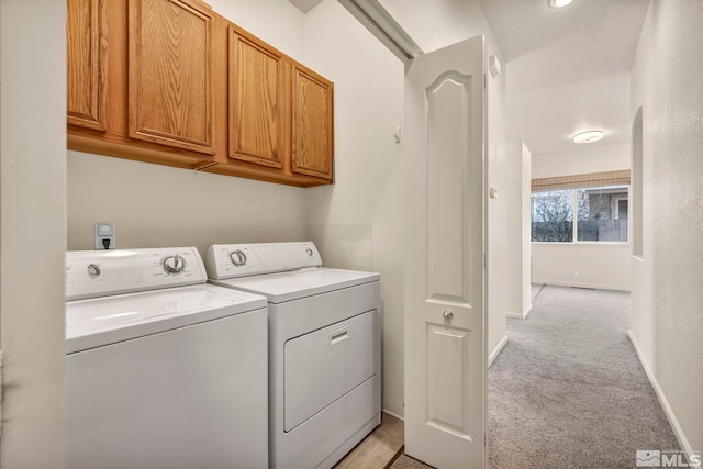 10055 Zephyr Heights Dr, Reno, NV 89521 - laundry room featuring cabinet space, light colored carpet, washing machine and dryer, and baseboards