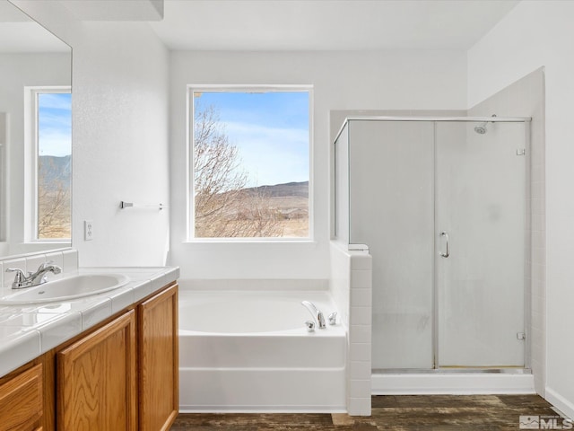 915 Lakeview Dr, Dayton, NV 89403 - bathroom featuring wood finished floors, a stall shower, vanity, and a garden tub