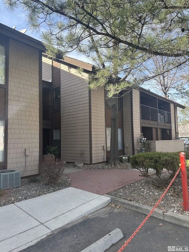 1465 E Peckham Ln Apt 40, Reno, NV 89502 - view of property exterior with cooling unit and uncovered parking