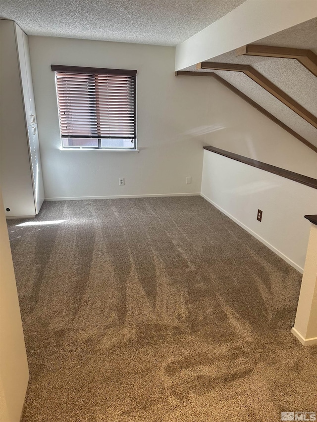 1465 E Peckham Ln Apt 40, Reno, NV 89502 - unfurnished room with a textured ceiling, carpet flooring, and vaulted ceiling