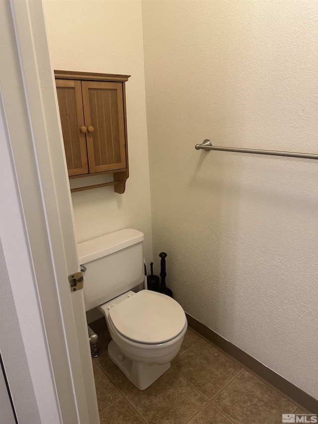 1465 E Peckham Ln Apt 40, Reno, NV 89502 - bathroom featuring toilet, tile patterned floors, and baseboards