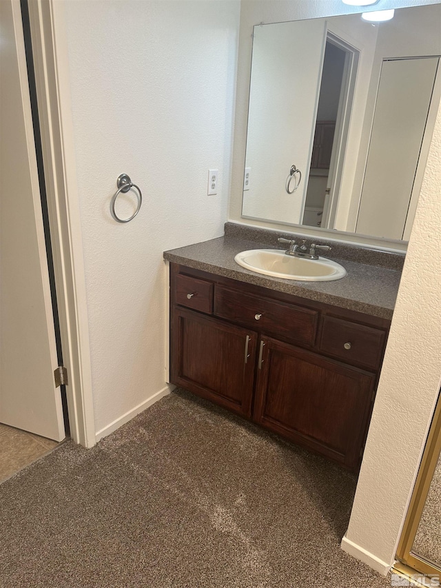 1465 E Peckham Ln Apt 40, Reno, NV 89502 - bathroom with vanity and carpet floors