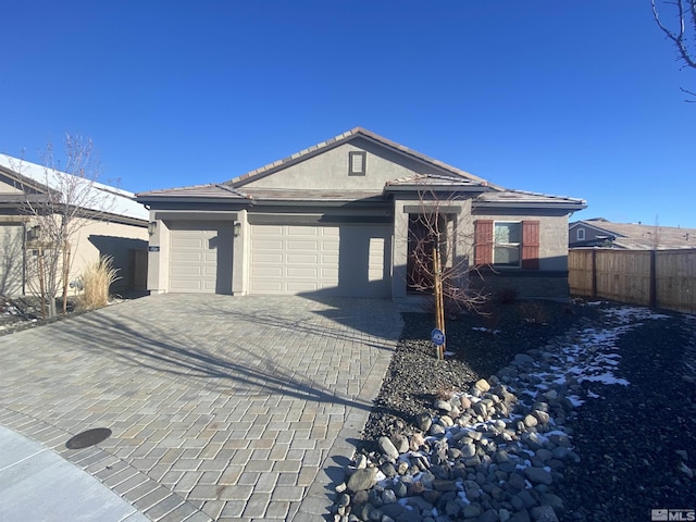 756 Iron Stirrup Ct, Sparks, NV 89436 - ranch-style home with an attached garage, decorative driveway, stucco siding, fence, and a tile roof