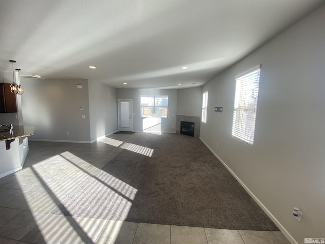 756 Iron Stirrup Ct, Sparks, NV 89436 - unfurnished living room with a fireplace, recessed lighting, baseboards, and carpet