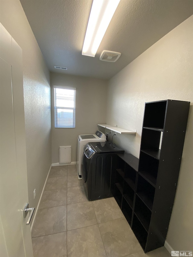 756 Iron Stirrup Ct, Sparks, NV 89436 - washroom featuring independent washer and dryer, light tile patterned floors, and a textured ceiling