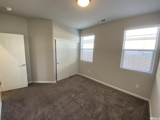 756 Iron Stirrup Ct, Sparks, NV 89436 - unfurnished bedroom featuring dark carpet, a closet, and baseboards