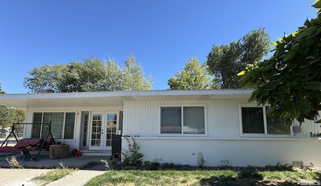 96 E Eisenhower Ave, Winnemucca, NV 89445 - single story home with french doors, concrete block siding, and a patio area