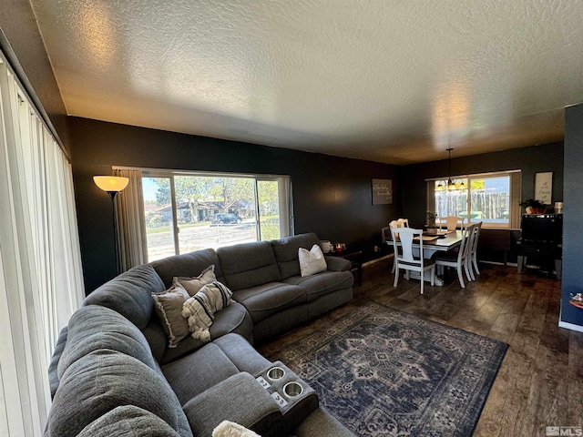 96 E Eisenhower Ave, Winnemucca, NV 89445 - living area with wood finished floors, plenty of natural light, and a textured ceiling