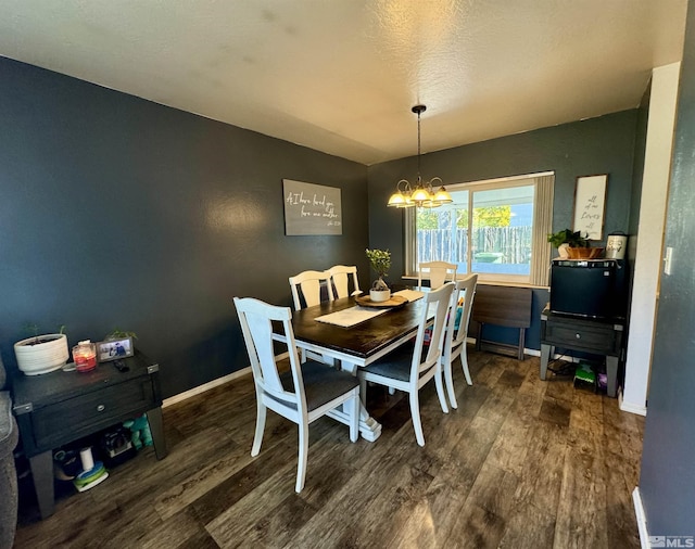 96 E Eisenhower Ave, Winnemucca, NV 89445 - dining area with wood finished floors, a chandelier, and baseboards