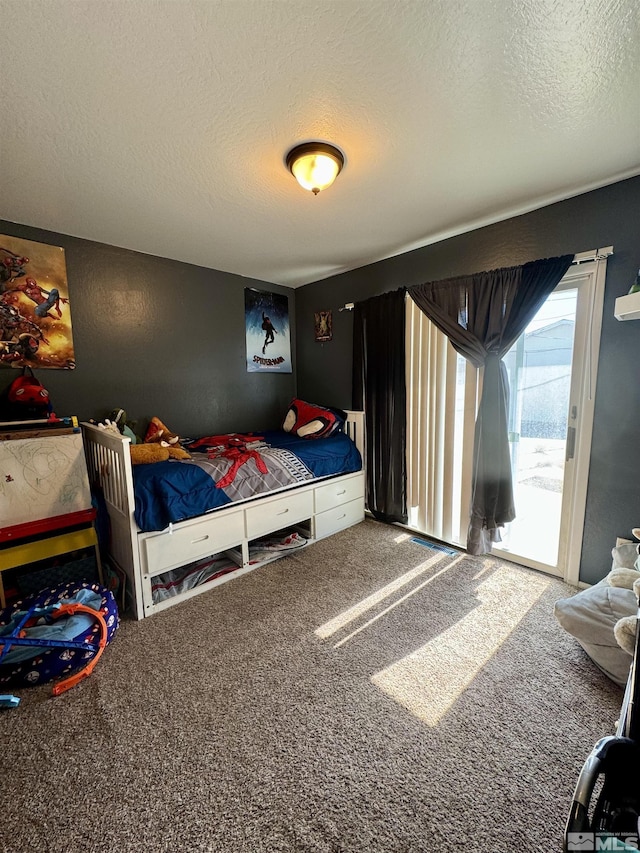96 E Eisenhower Ave, Winnemucca, NV 89445 - carpeted bedroom featuring a textured ceiling and access to exterior
