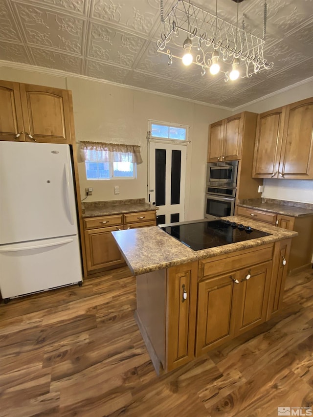85 S Main, Paradise Valley, NV 89426 - kitchen featuring stainless steel appliances, an ornate ceiling, dark wood-style floors, brown cabinetry, and a kitchen island