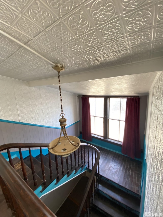 85 S Main, Paradise Valley, NV 89426 - stairs featuring wood-type flooring, an ornate ceiling, and a wainscoted wall