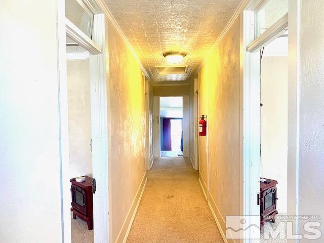 85 S Main, Paradise Valley, NV 89426 - hall with crown molding, light colored carpet, and baseboards