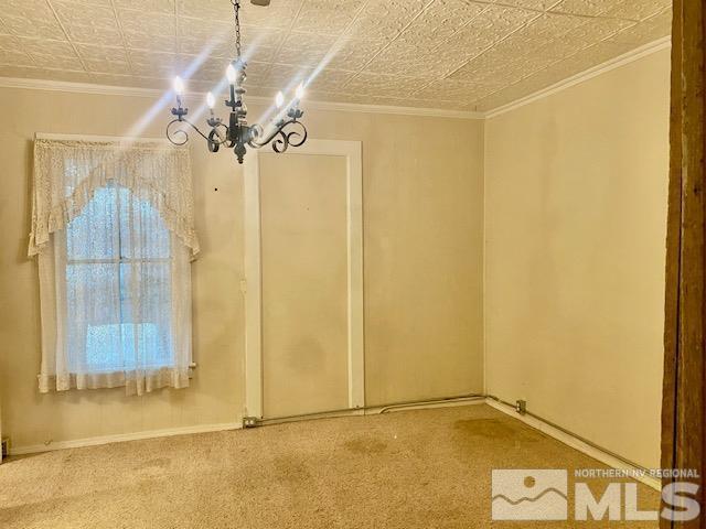 85 S Main, Paradise Valley, NV 89426 - carpeted spare room featuring a chandelier, an ornate ceiling, ornamental molding, and baseboards