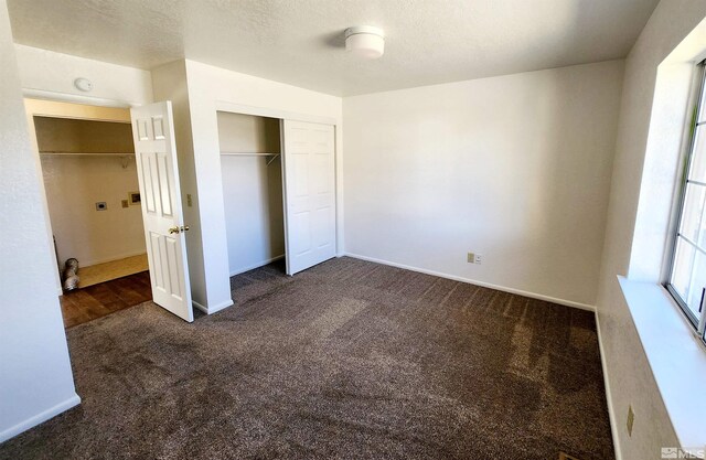 450 Pintail Dr, Fallon, NV 89406 - unfurnished bedroom featuring dark carpet, a closet, and baseboards