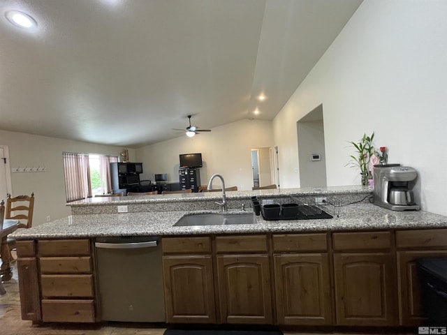 kitchen with dishwasher, a sink, ceiling fan, lofted ceiling, and light stone counters