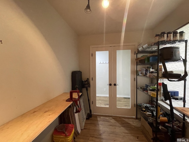 doorway with french doors and hardwood / wood-style flooring