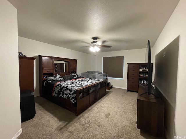 bedroom with light carpet, baseboards, and a ceiling fan