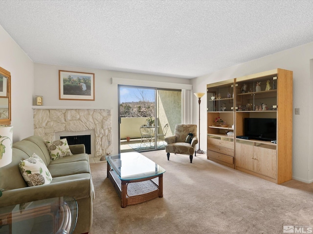2845 Idlewild Dr # 210, Reno, NV 89509 - living room featuring light colored carpet, a textured ceiling, and a stone fireplace