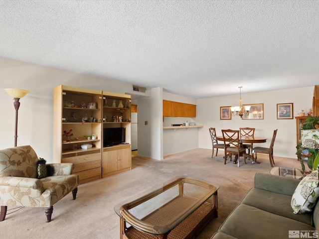 2845 Idlewild Dr # 210, Reno, NV 89509 - living area with light carpet, a chandelier, and a textured ceiling