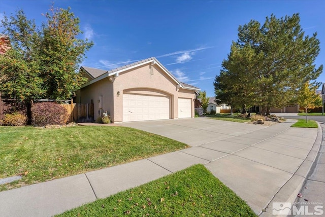 view of front facade featuring an attached garage, concrete driveway, and stucco siding