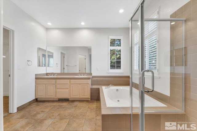 full bathroom featuring a stall shower, a garden tub, double vanity, and recessed lighting