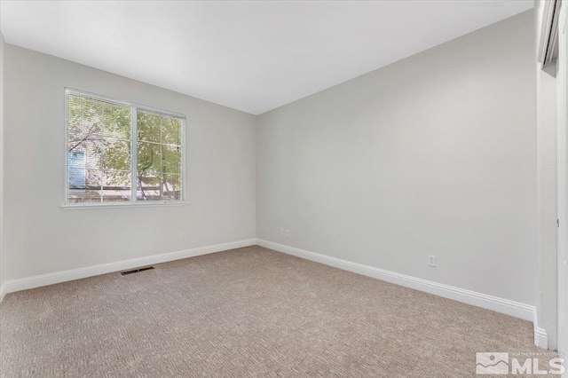 unfurnished room featuring carpet flooring and baseboards