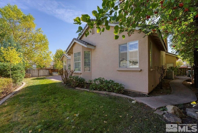 view of side of home with stucco siding and central air condition unit